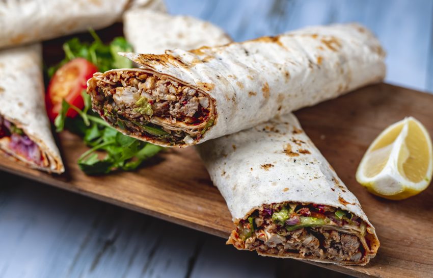 side view chicken doner with greens cucumber tomato sauce cucumber red onion in pita and slice of lemon on a board SSUCv3H4sIAAAAAAAACpyRy47DIAxF9yPNP0SsGylp0jz6K9UszKMJKoUKyIxGVf99DISK9Wyi+Ni+9jXPz4+qIhScZORcPUOEsVRqc96Cl0Yjbg47t0JzYUsiuPTGSlAlpODZquEuEOpNqYBfMUmcB7854cKwHTHwYkGNBN8SaaNLiquciEnswBQhh4K5jUaWURL/V2f6+cpuYBGa/caFCyNWKAHJyCWVktuPF/ZeWoONS1O4+jYMVCjoCqWHlUzqpWgzfo1Xzm3MbNrbsMJ7c6KMeQBV4cRX1BSZr+AclvPMi0EM39Tcizna+GhgVyUcXyKEbXfs2mlsu6lph7HvxuNekF5vlagT18lCGLOb5KV1GTYgA5vHvmm6up9m/AxzU1M6jPXYnq58Ok1DQyc8/OsPAAD//wMAoNhDT4cCAAA=